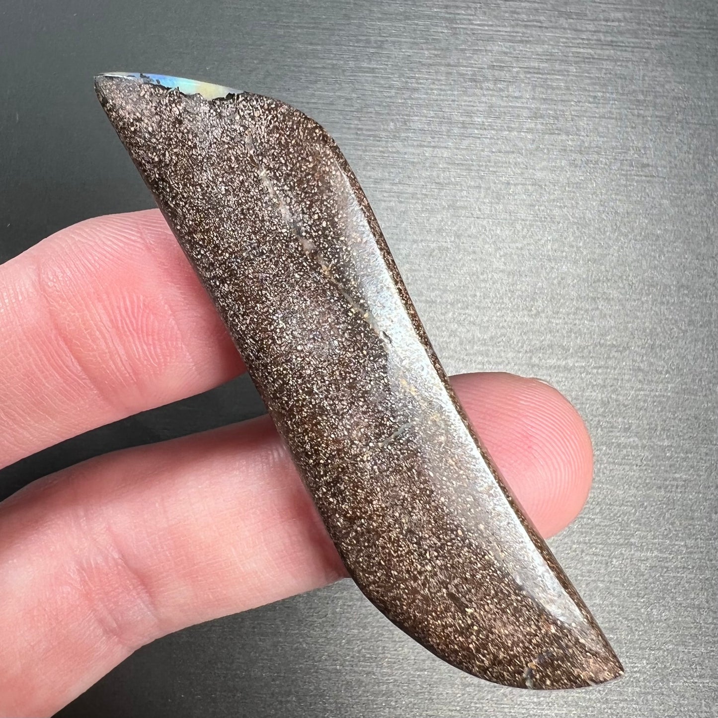 A large, loose, polished Quilpie boulder opal stone from Queensland, Australia. The stone is blue.