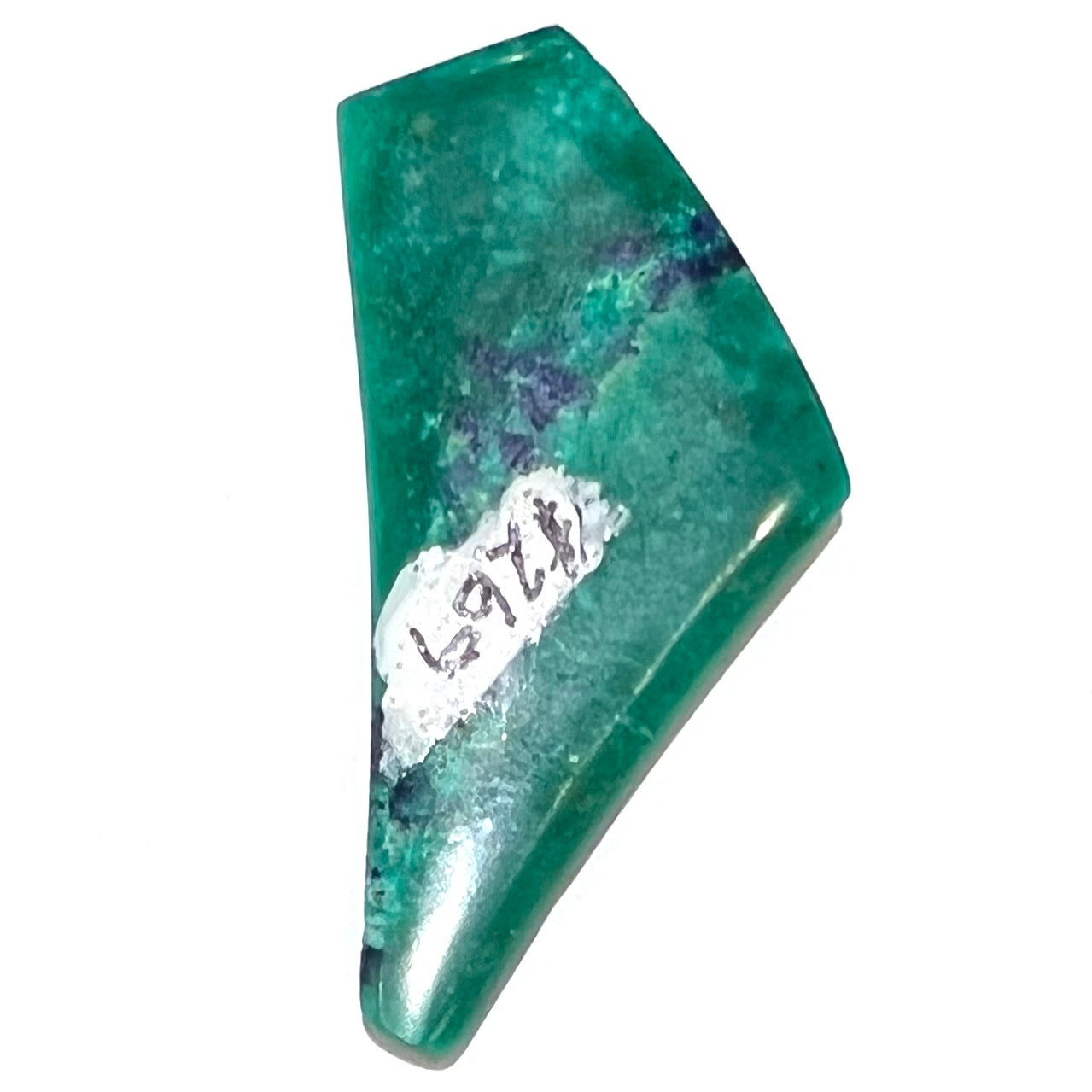 A loose triangular freeform cabochon cut green chrysocolla with blue azurite inclusions.