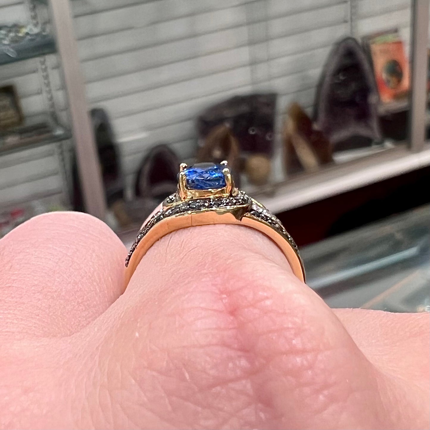 A ladies' oval cut blue kyanite twist ring pave set with blue and white diamond accents.