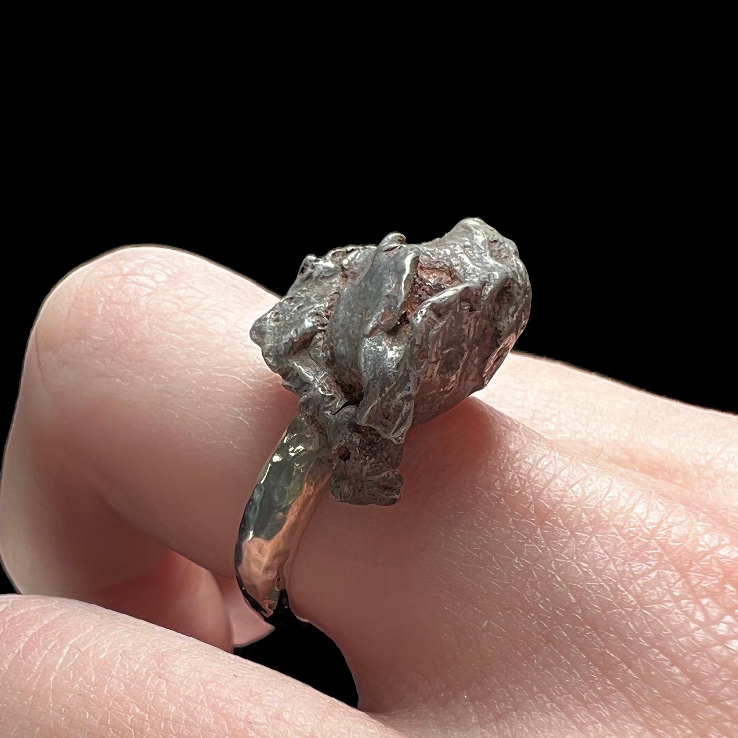 A sterling silver ring set with a Campo del Cielo meteorite.