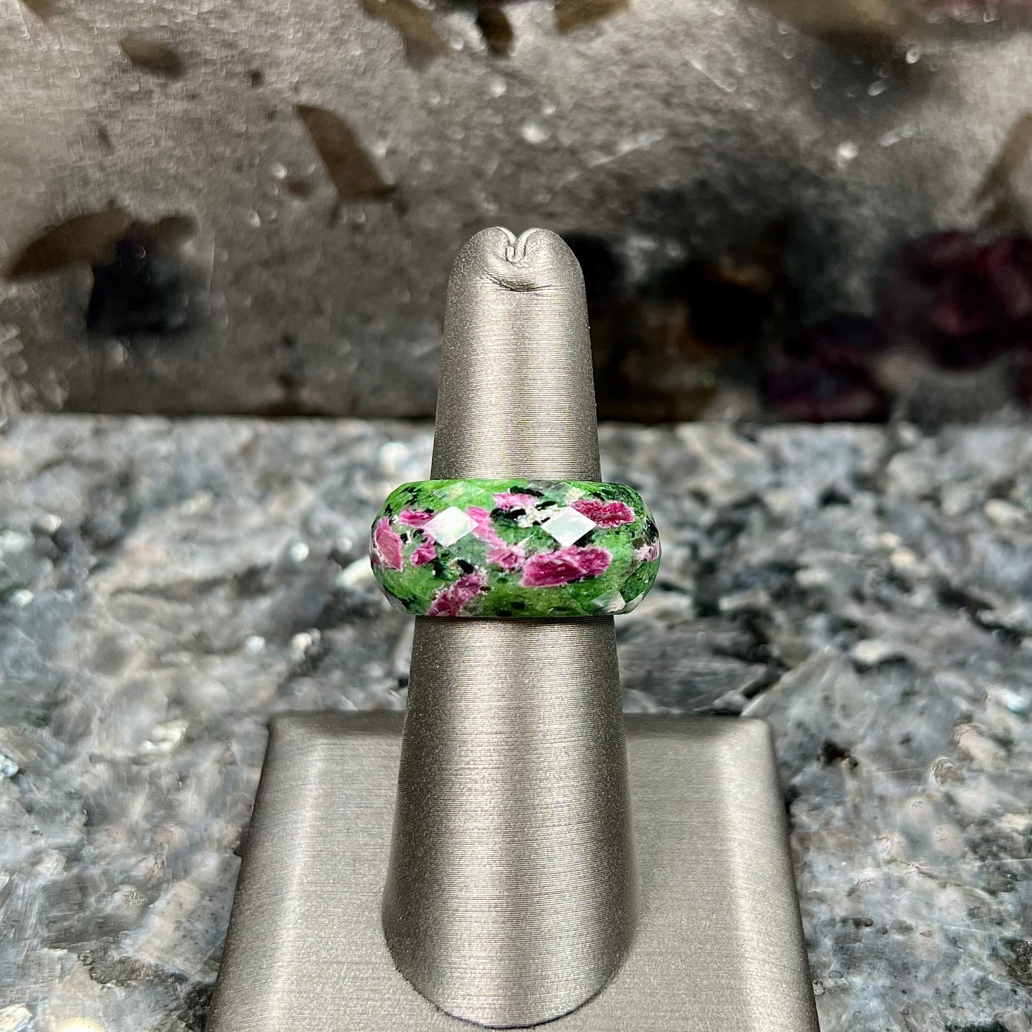 A faceted, carved stone ring made form ruby in zoisite.