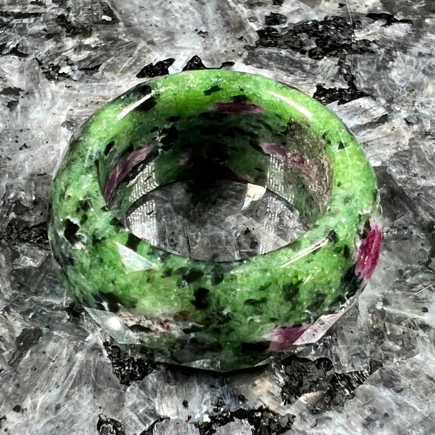 A faceted, carved stone ring made form ruby in zoisite.