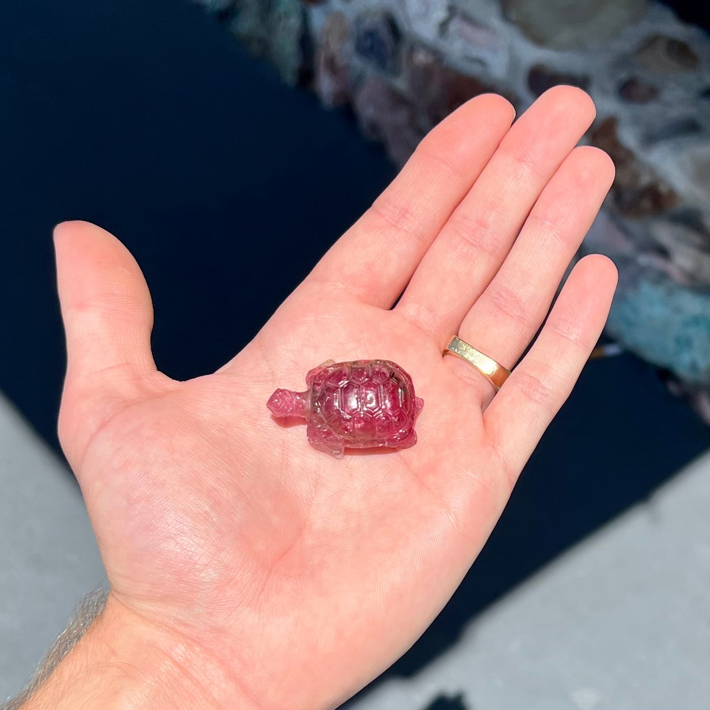 A crystal turtle carved from a pink tourmaline stone.