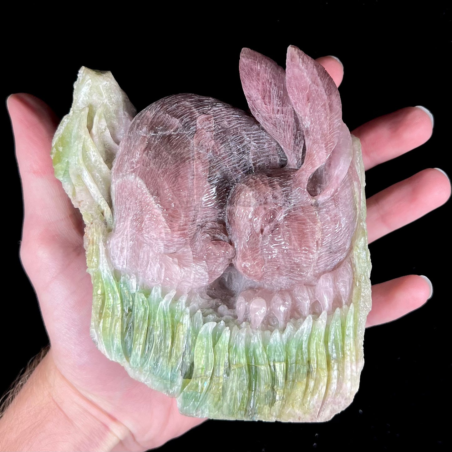 A stone rabbit carved from a conglomeration of watermelon tourmaline crystals by artist, Ronald Stevens.