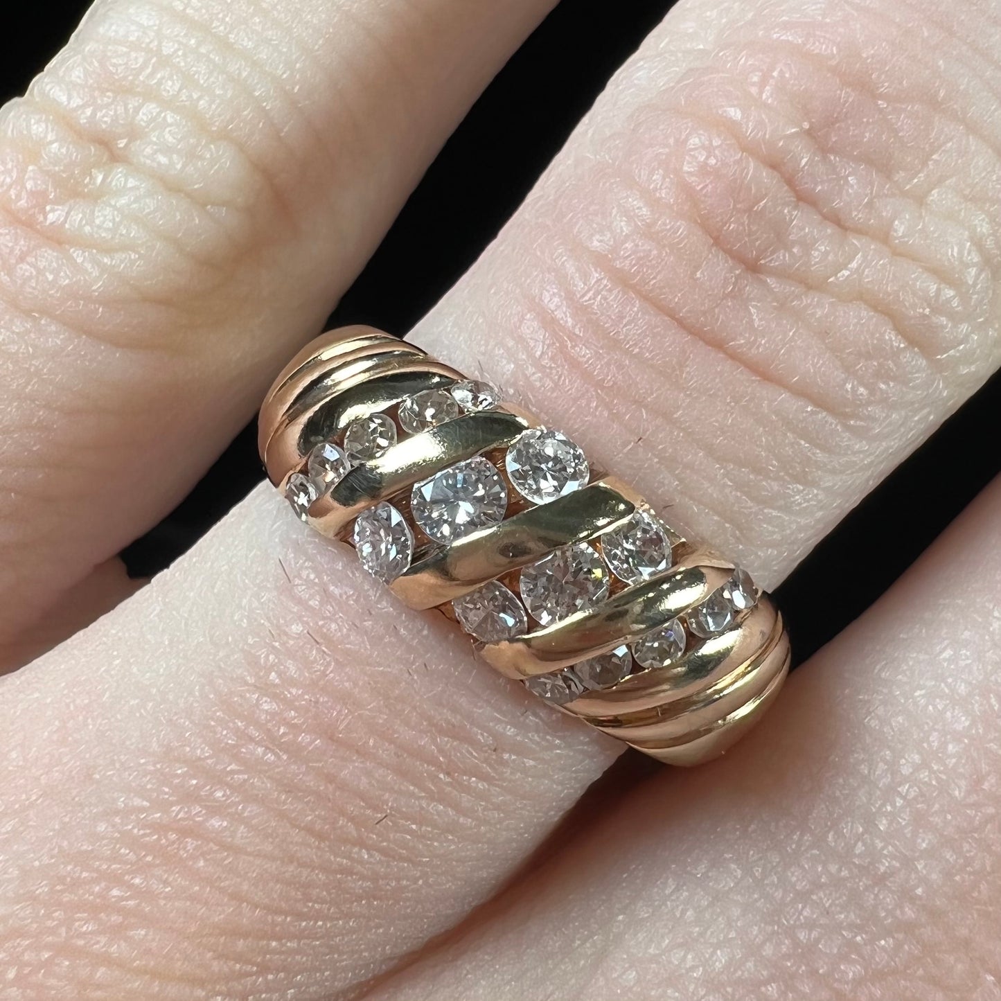 A ladies' channel set gold diamond ring.