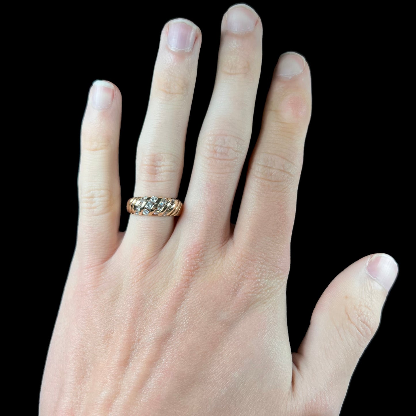 A ladies' channel set gold diamond ring.