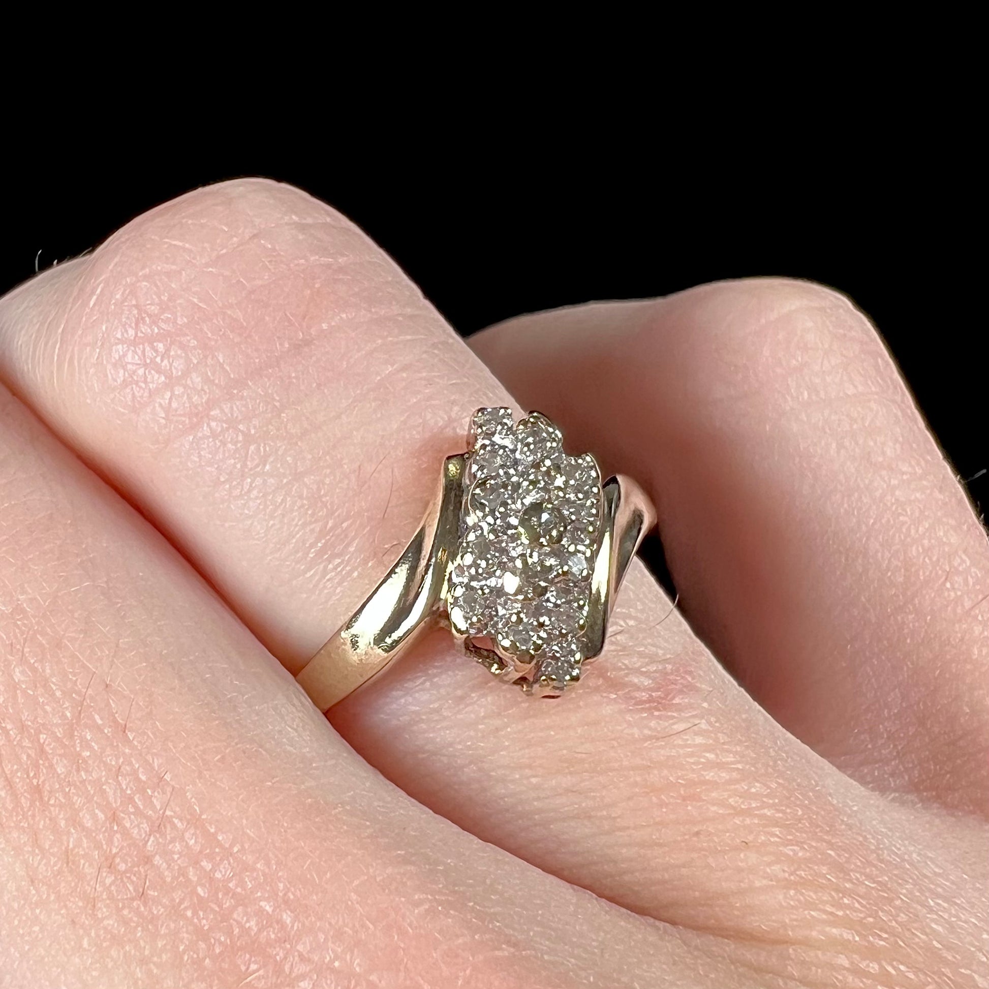 A ladies' estate yellow gold diamond cluster ring.  The diamonds are round single cuts.