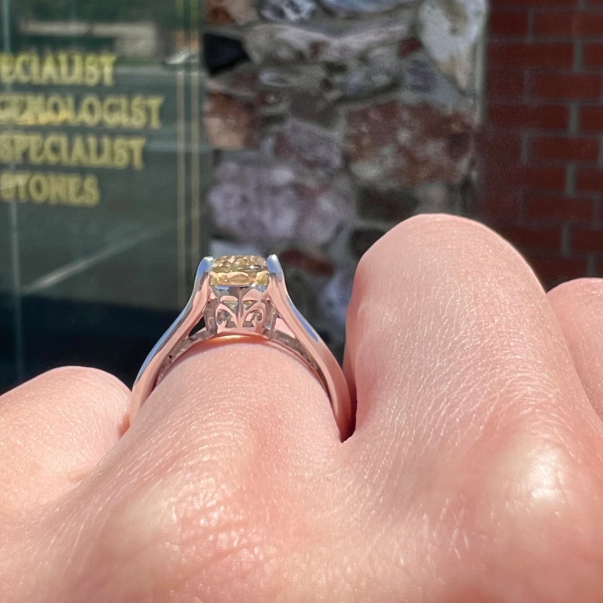 A sterling silver oval cut citrine ring set with canary yellow diamond accents.