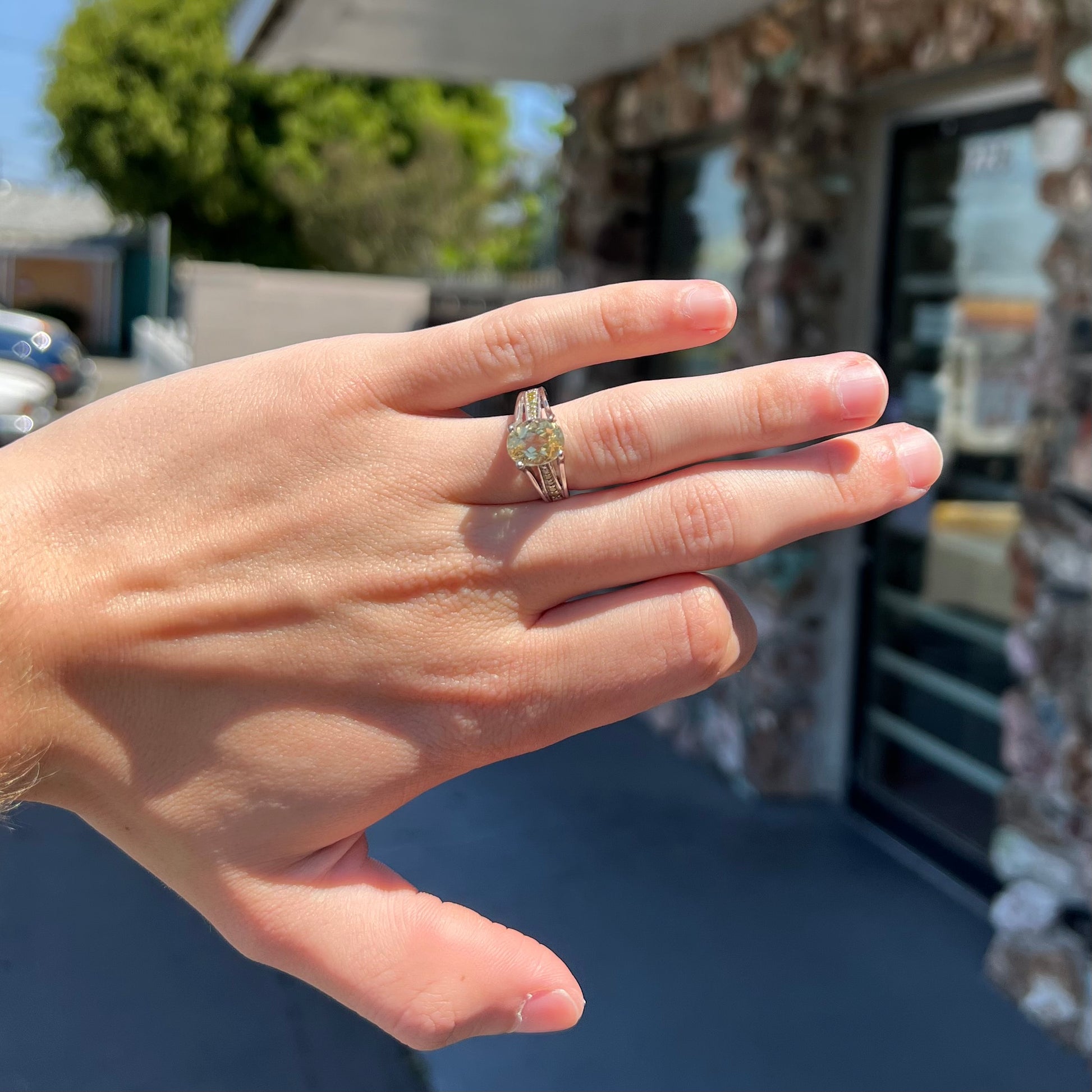 A sterling silver oval cut citrine ring set with canary yellow diamond accents.