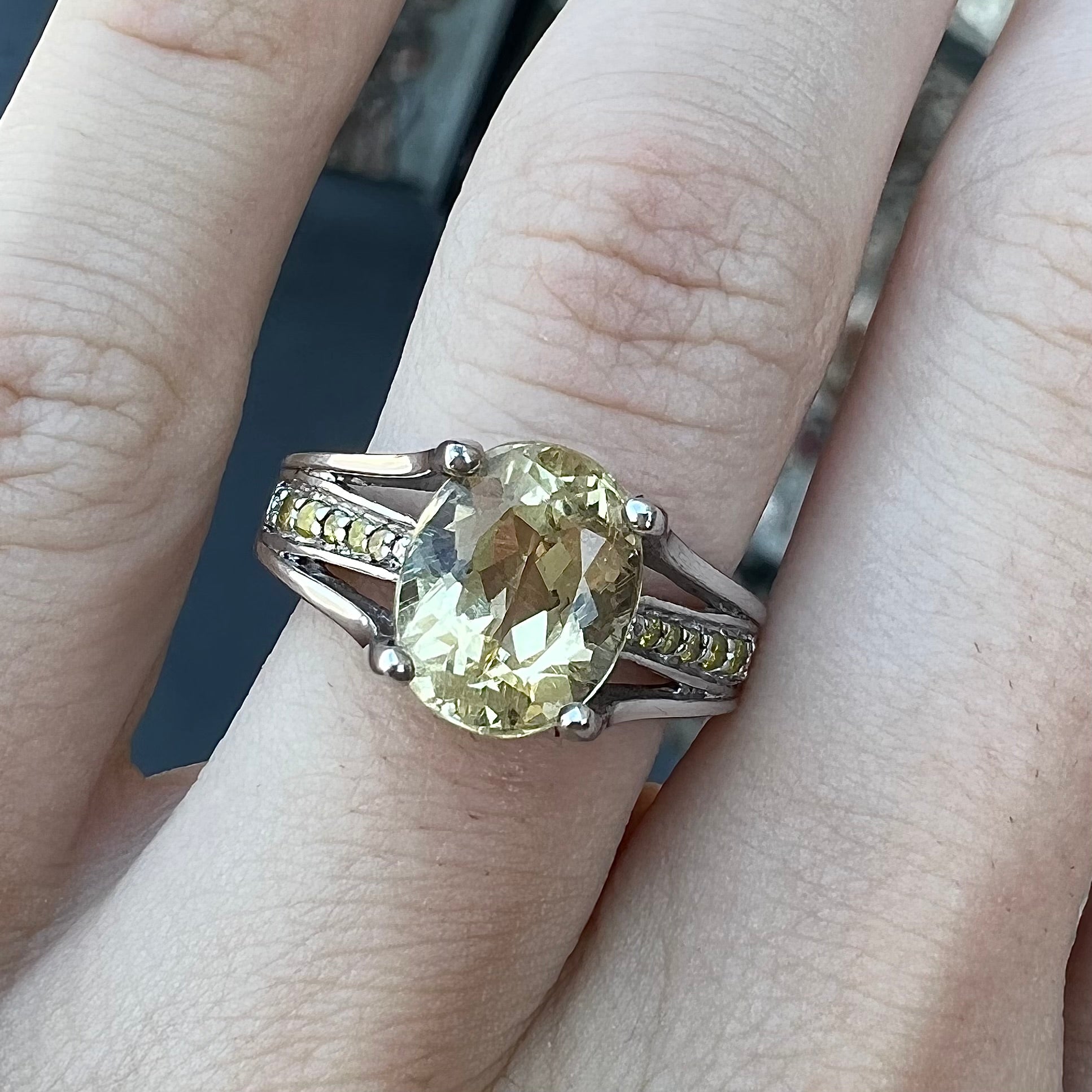 A sterling silver oval cut citrine ring set with canary yellow diamond accents.