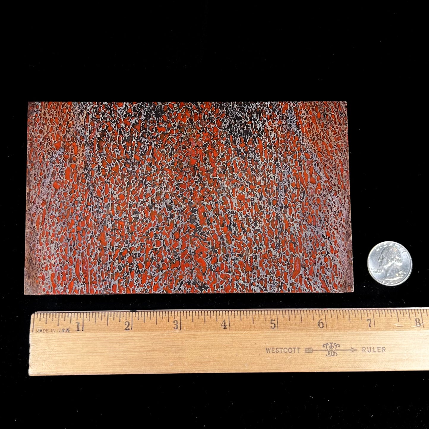 A custom stone box handmade by Gems Art Studio from polished red dinosaur bone and blue pietersite.