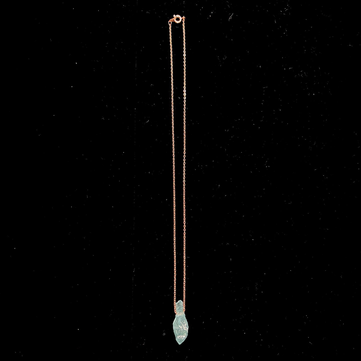 A drilled aquamarine crystal necklace on a copper cable chain.