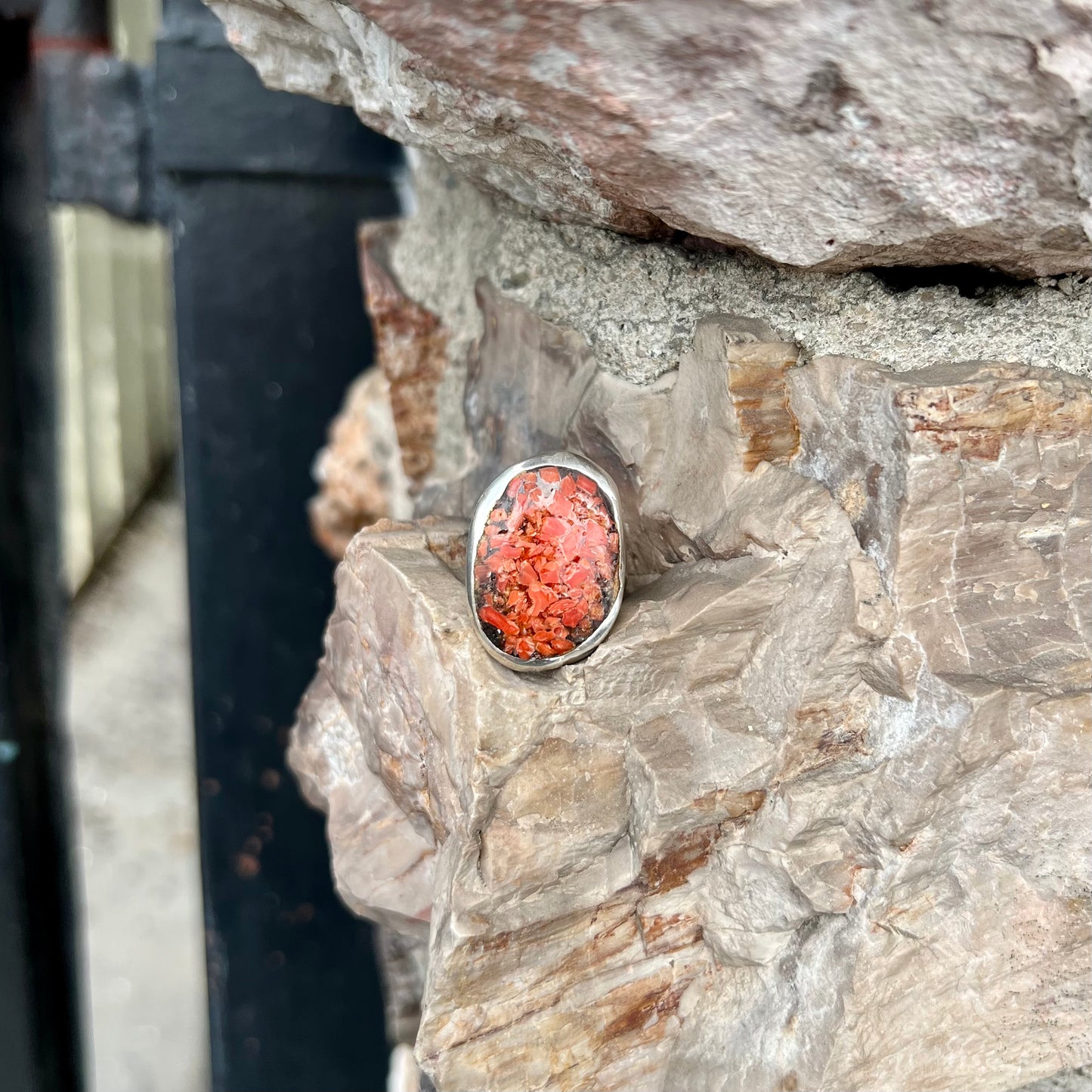 A rustic style, handmade silver men's ring set with crushed red coral.