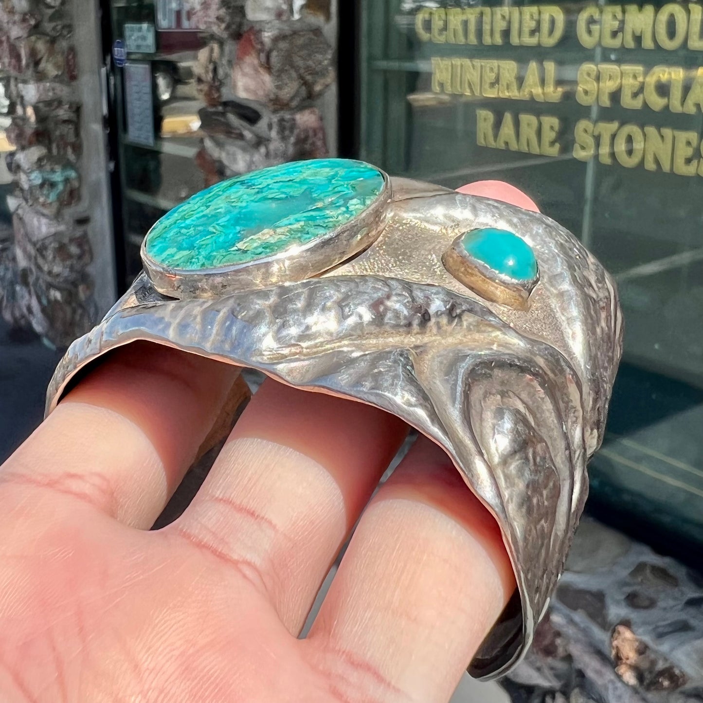 A men's sterling silver cuff bracelet set with two oval cut chrysocolla stones.