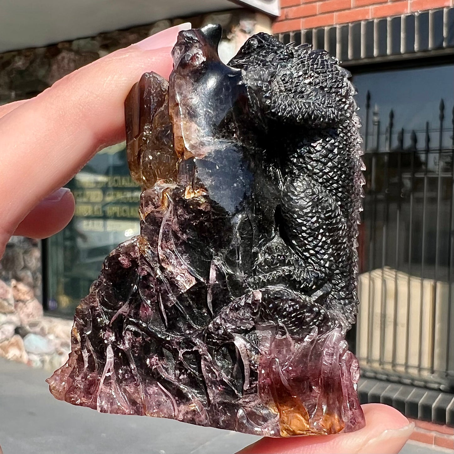 A stone lizard carved by artist, Ronald Stevens, from a liddicoatite tourmaline crystal.