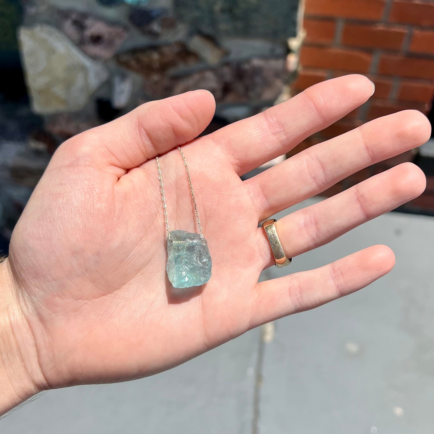 A drilled aquamarine crystal necklace on a silver wheat chain.