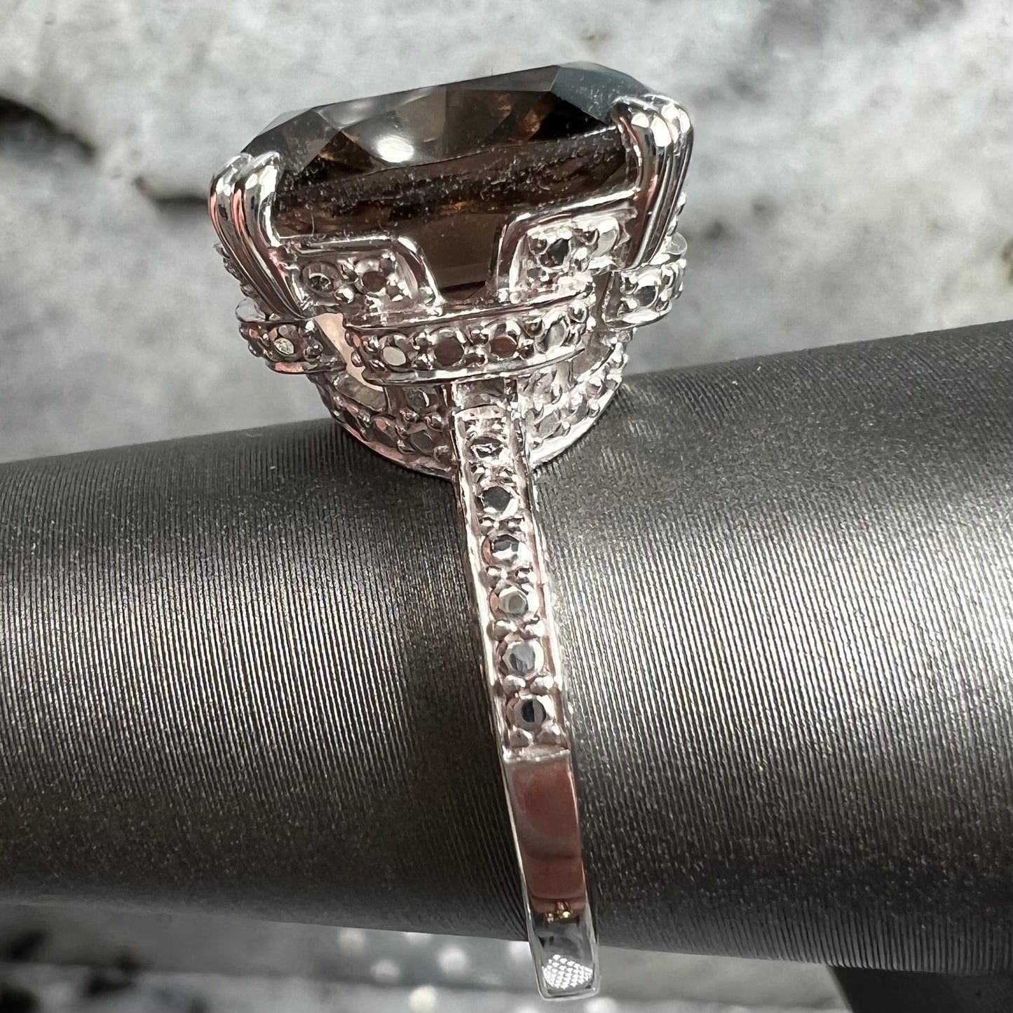 A sterling silver, cushion cut smoky quartz solitaire ring.