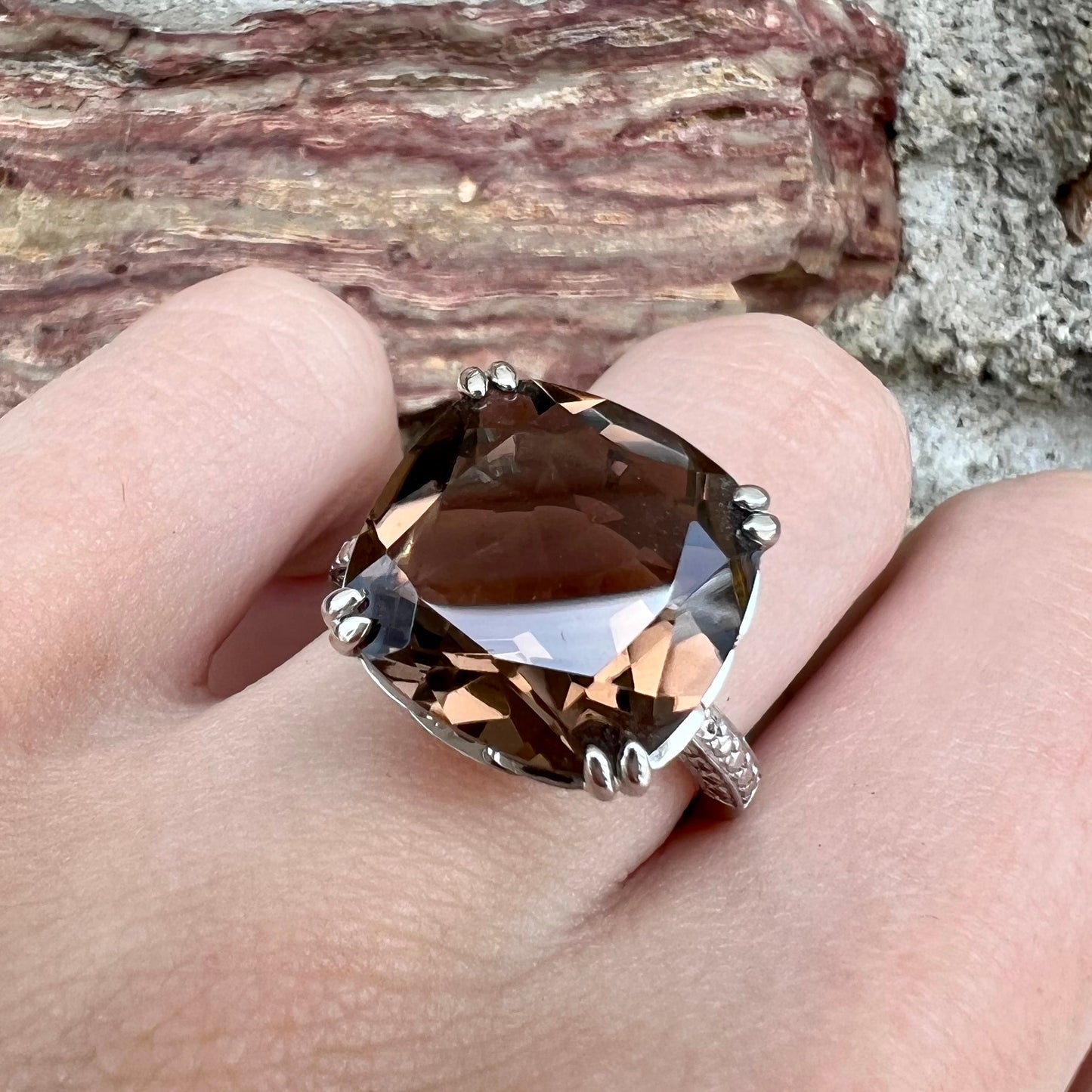 A sterling silver, cushion cut smoky quartz solitaire ring.