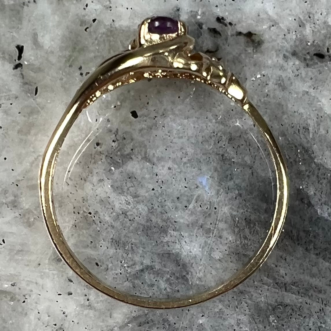 A yellow gold oval cut amethyst and diamond accent ladies' ring.