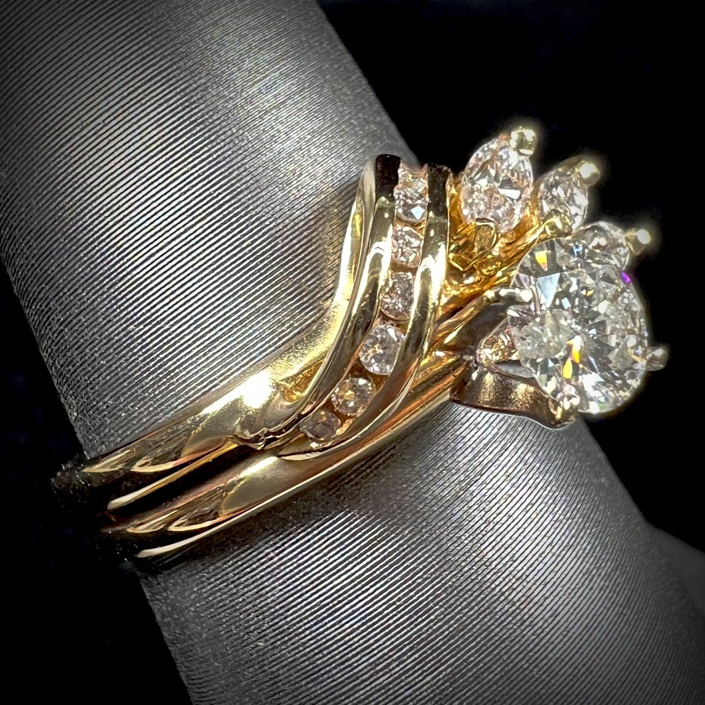 A ladies' diamond wedding set that has been soldered together in yellow gold. There are round and marquise cut diamonds.