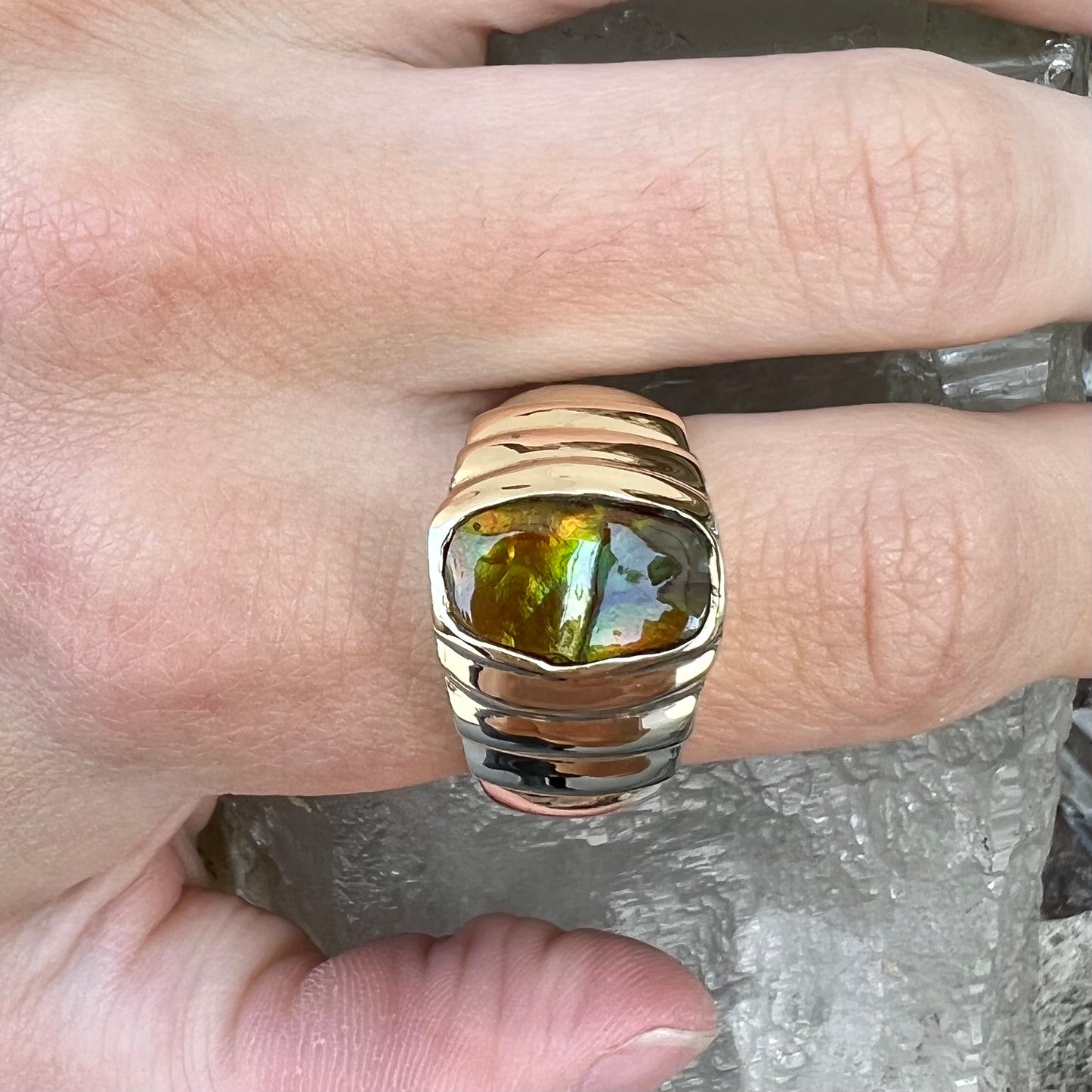 Men's fire agate solitaire ring cast in yellow gold. The ring is a step design.