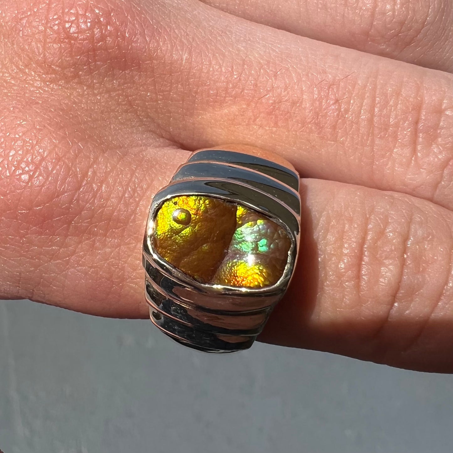 Men's fire agate solitaire ring cast in yellow gold. The ring is a step design.