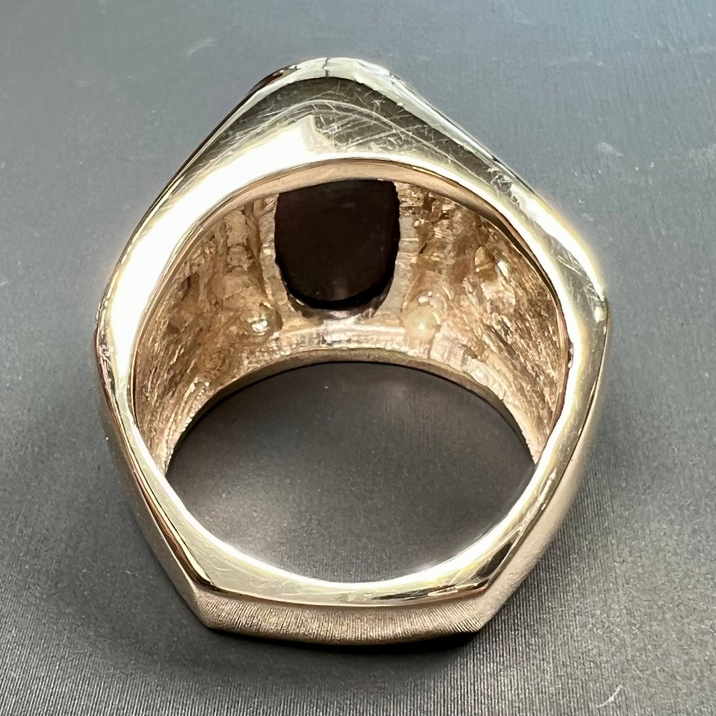 A men's solid yellow gold fire agate and diamond ring. The fire agate displays predominantly red and green.