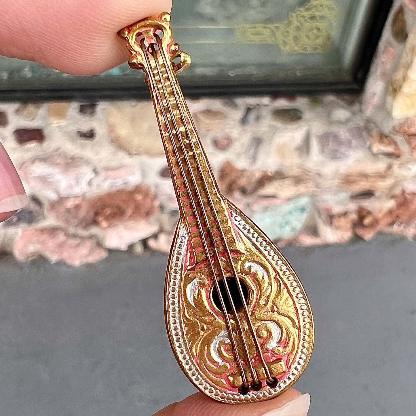 A gold filled mandolin brooch. The back of the pin is stamped "SPAIN."
