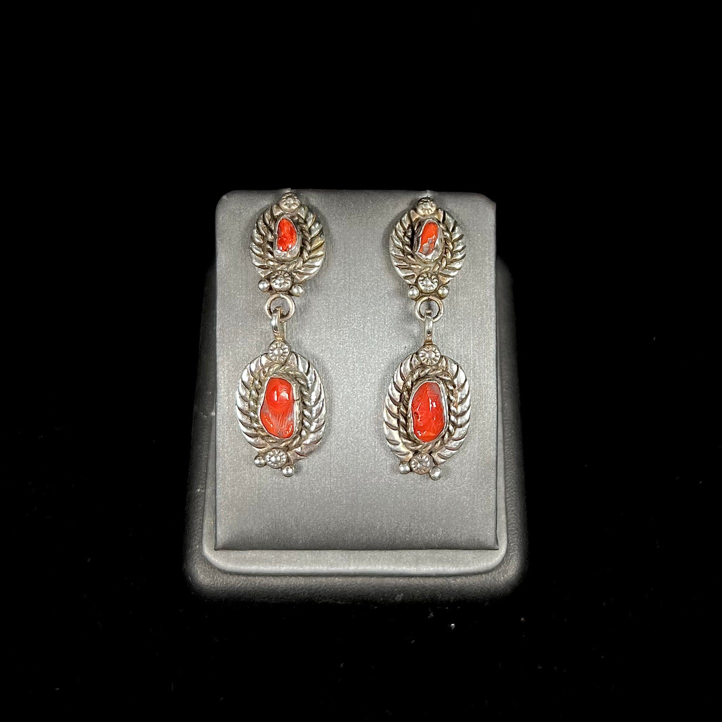 A pair of vintage coral branch dangle earrings handmade by Navajo artist, Delbert Chatter.