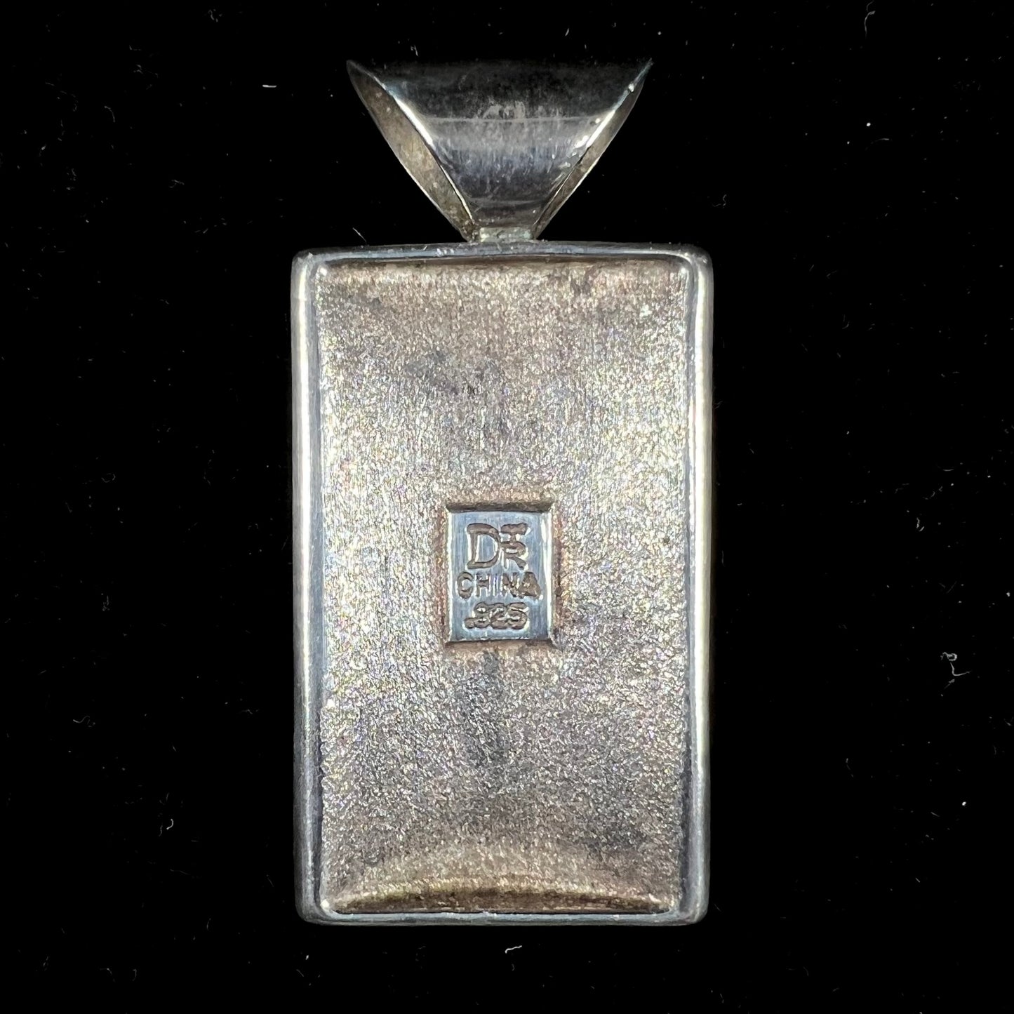 A silver pendant set with square cabochon cut turquoise and coral stones. The piece is stamped "DTR CHINA".