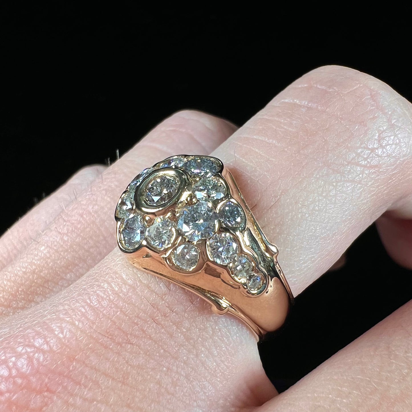 A yellow gold domed diamond ring set with 19 Standard Round Brilliant Cut diamonds.