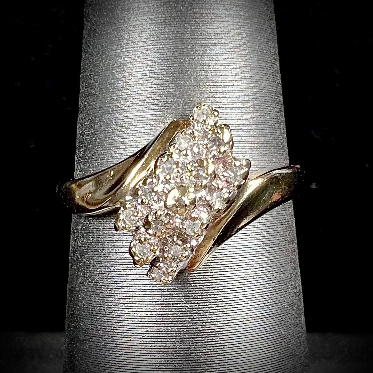 A ladies' estate yellow gold diamond cluster ring. The diamonds are round single cuts.