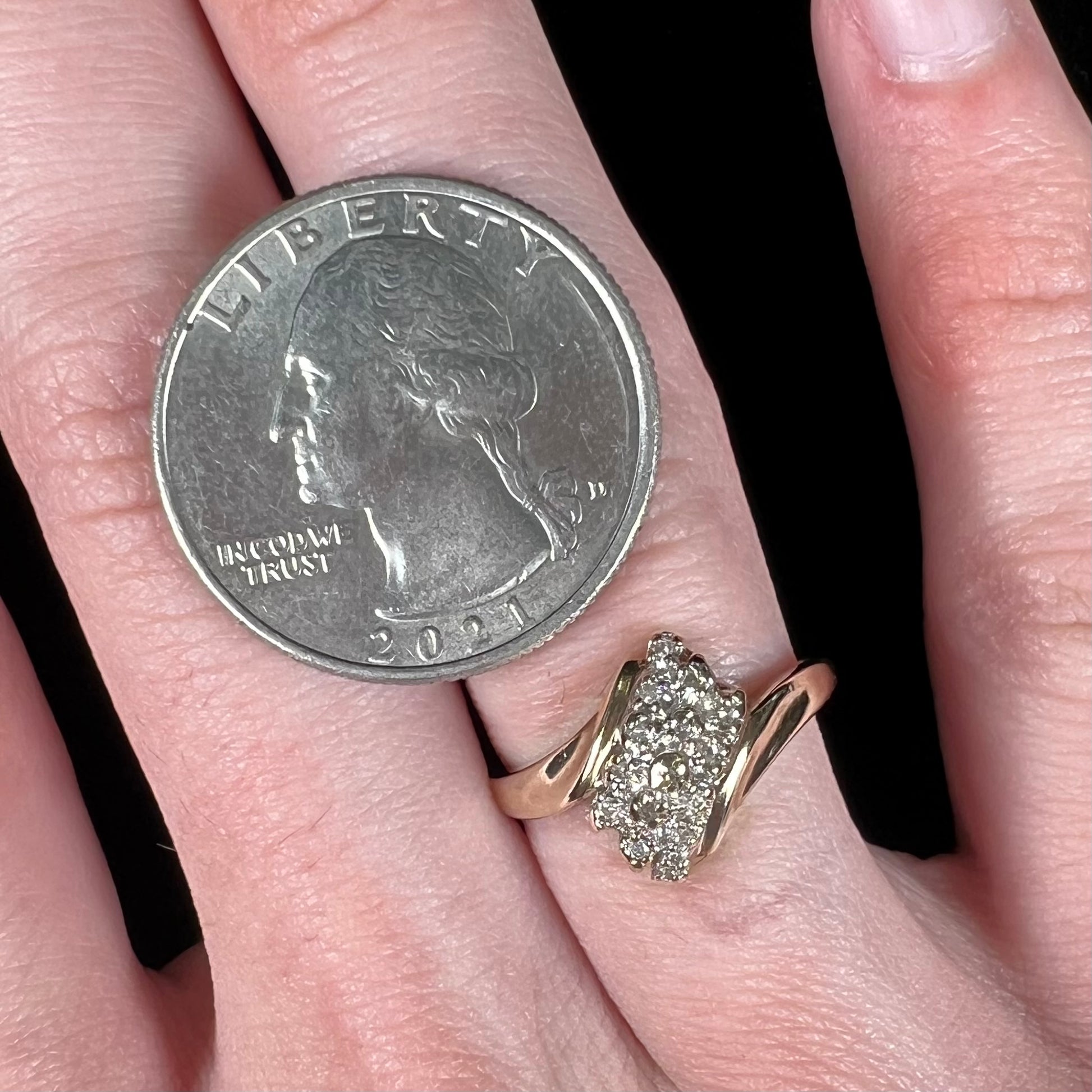 A ladies' estate yellow gold diamond cluster ring.  The diamonds are round single cuts.