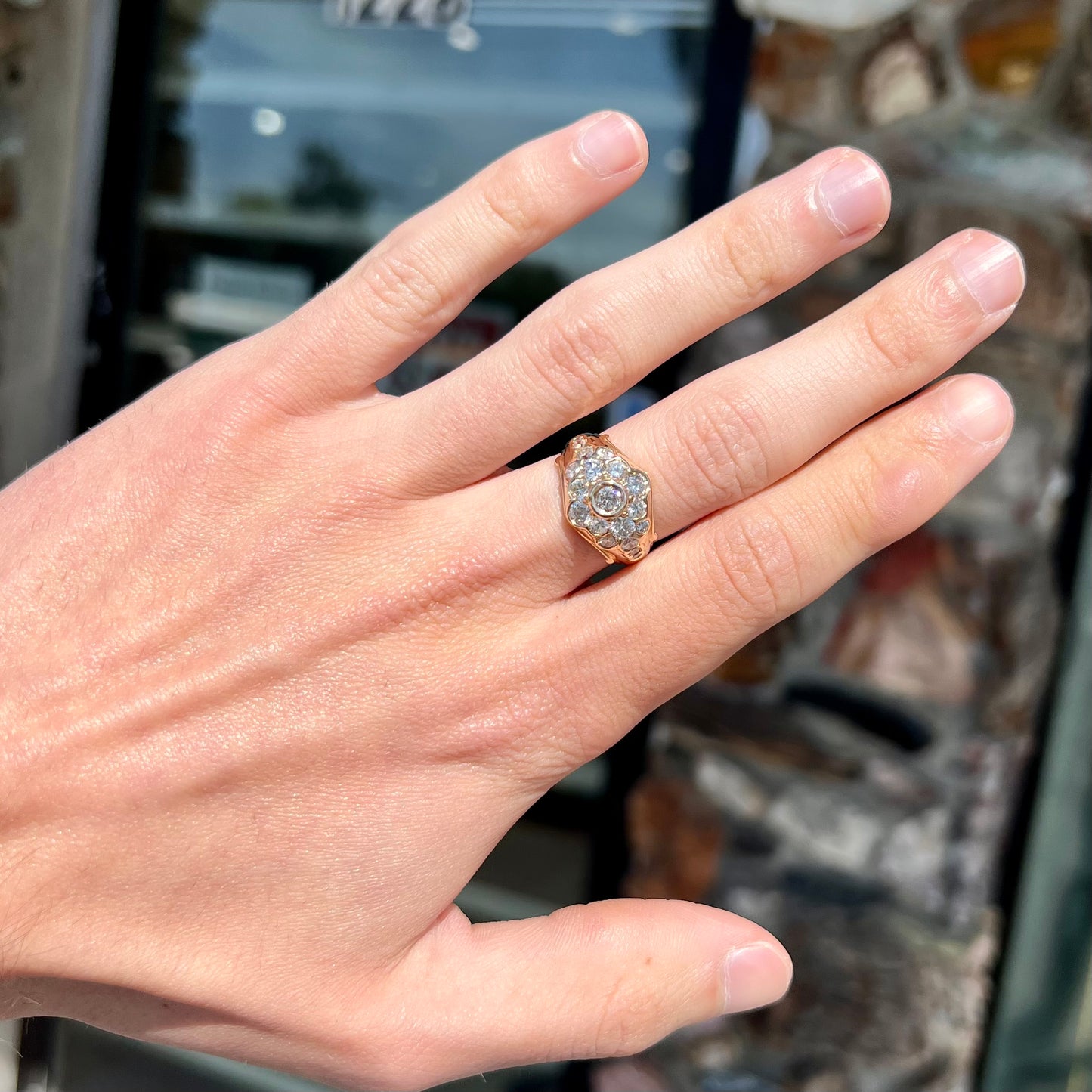 A yellow gold domed diamond ring set with 19 Standard Round Brilliant Cut diamonds.