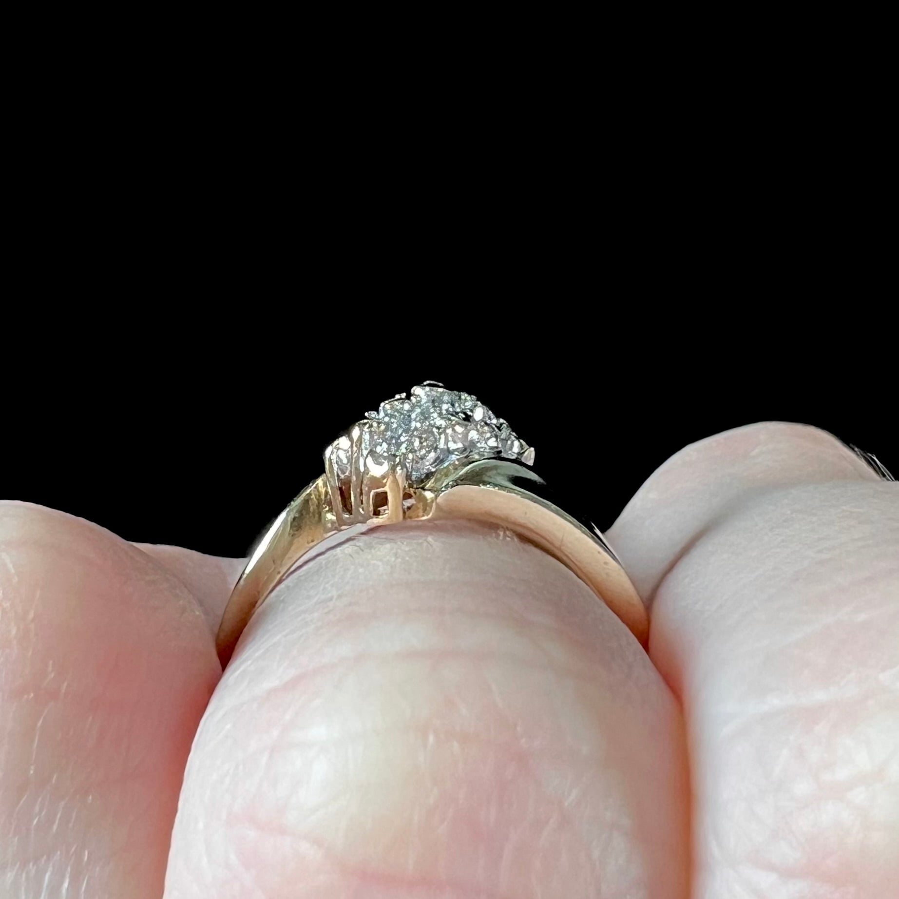 A ladies' estate yellow gold diamond cluster ring.  The diamonds are round single cuts.