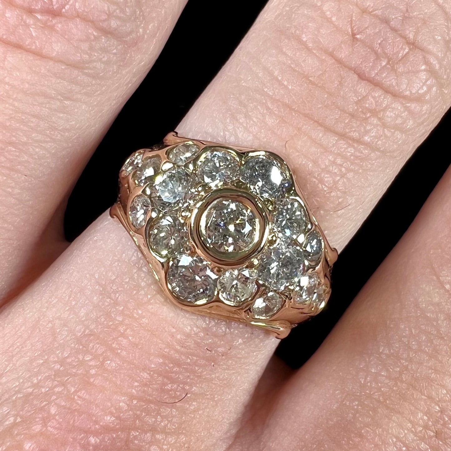 A yellow gold domed diamond ring set with 19 Standard Round Brilliant Cut diamonds.