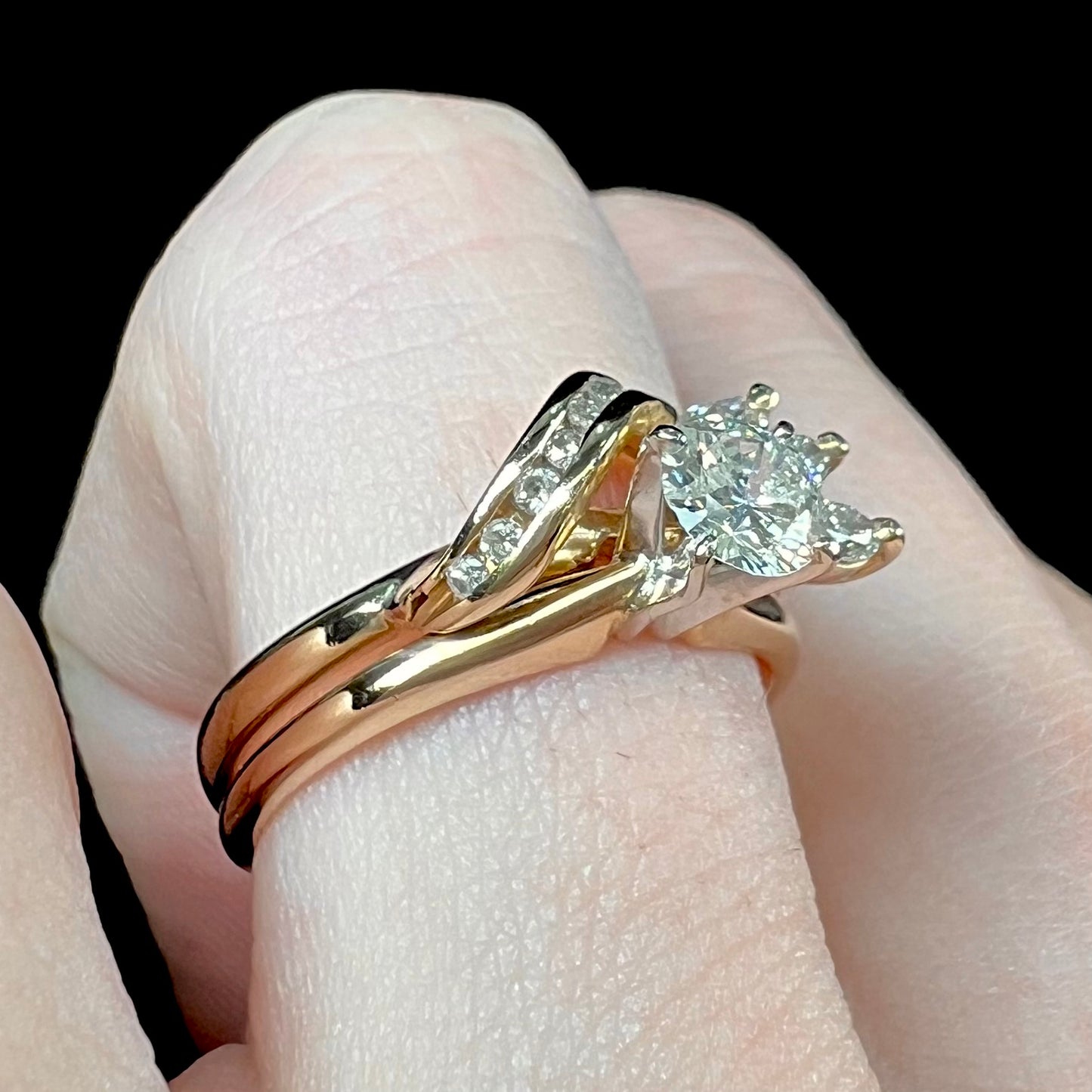 A ladies' diamond wedding set that has been soldered together in yellow gold. There are round and marquise cut diamonds.