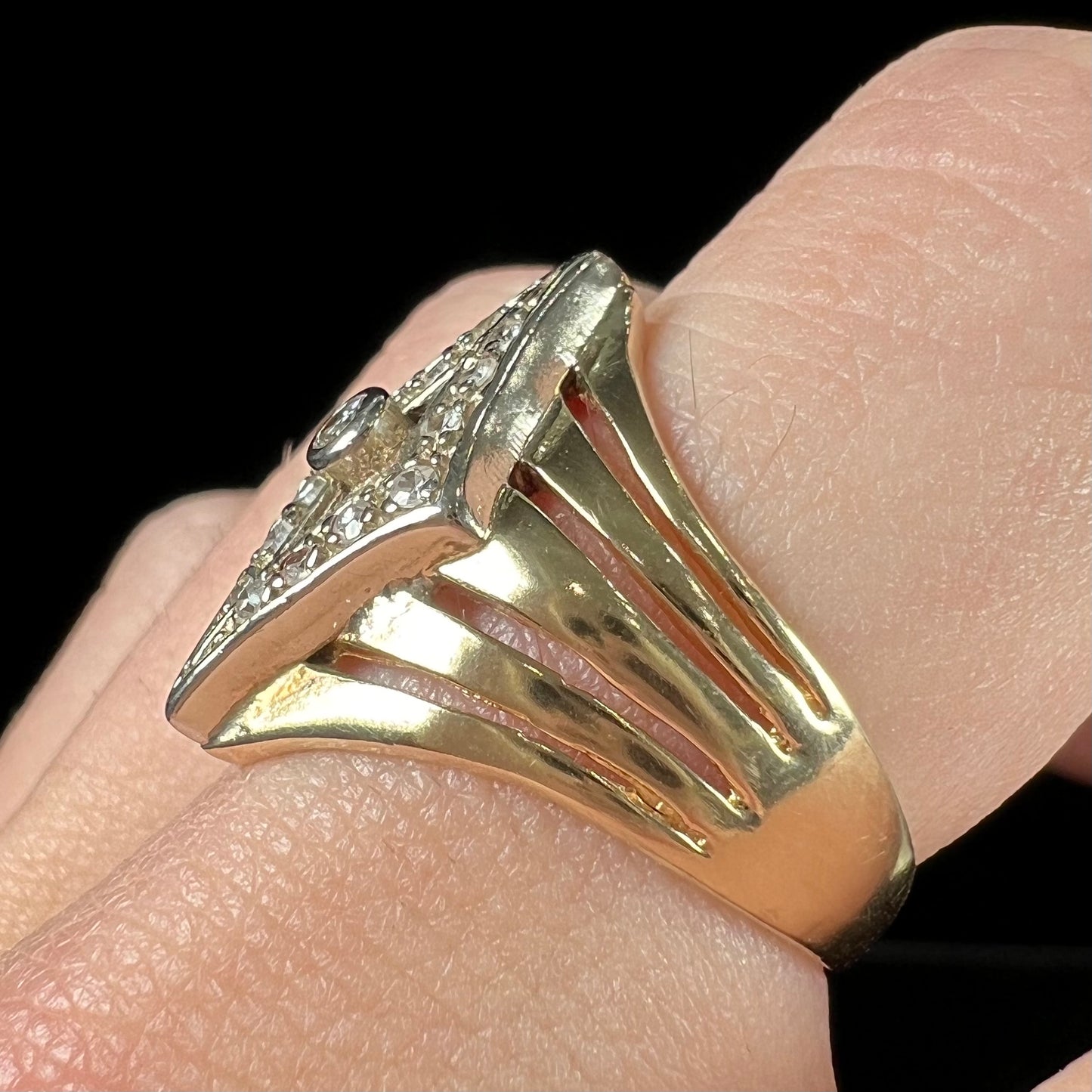 An estate ladies' gold diamond ring. The shape of the ring resembles an art deco style diamond.