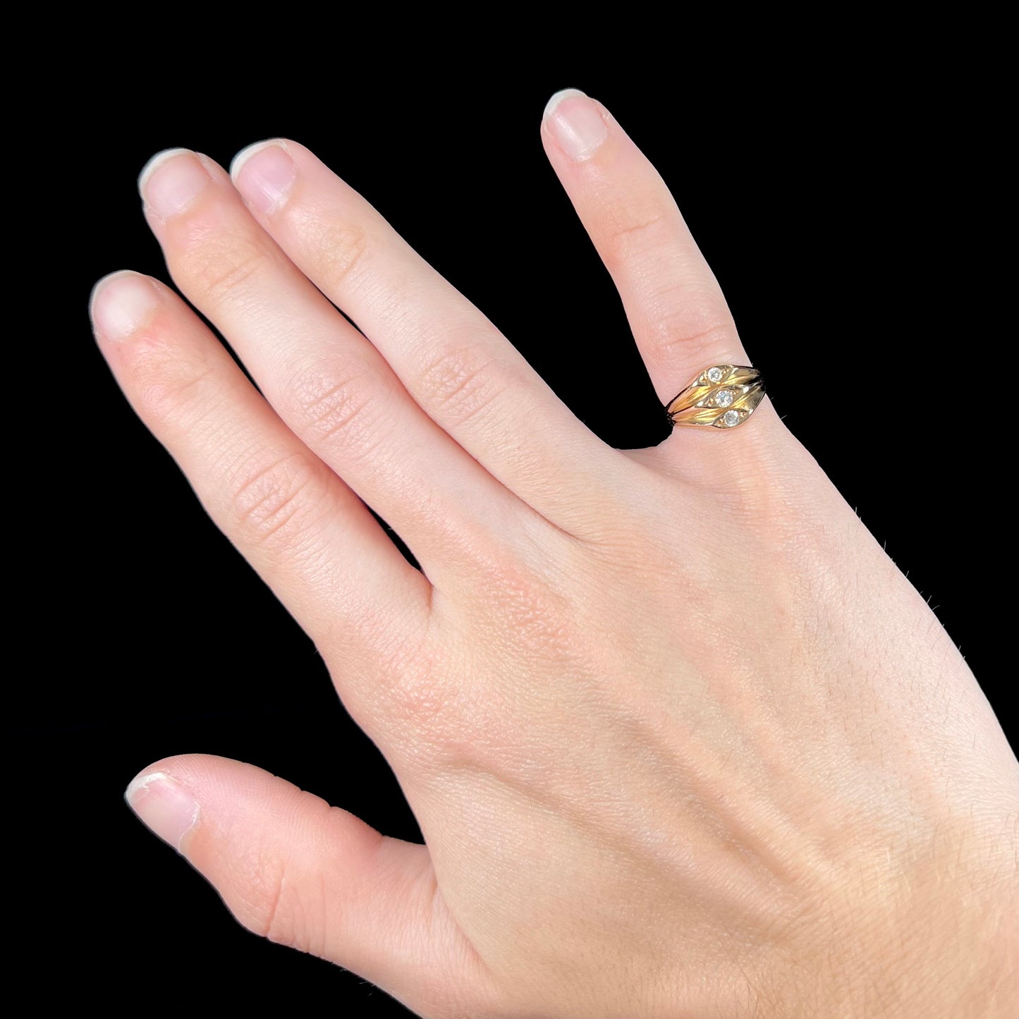 A vintage 1940's style ladies' yellow gold three stone diamond ring.