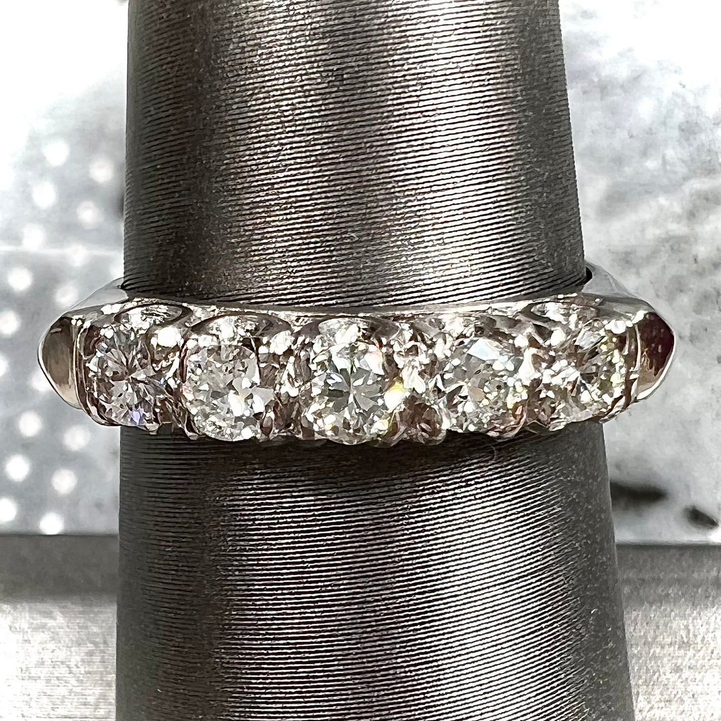A vintage style ladies' platinum wedding band set with five round diamonds.