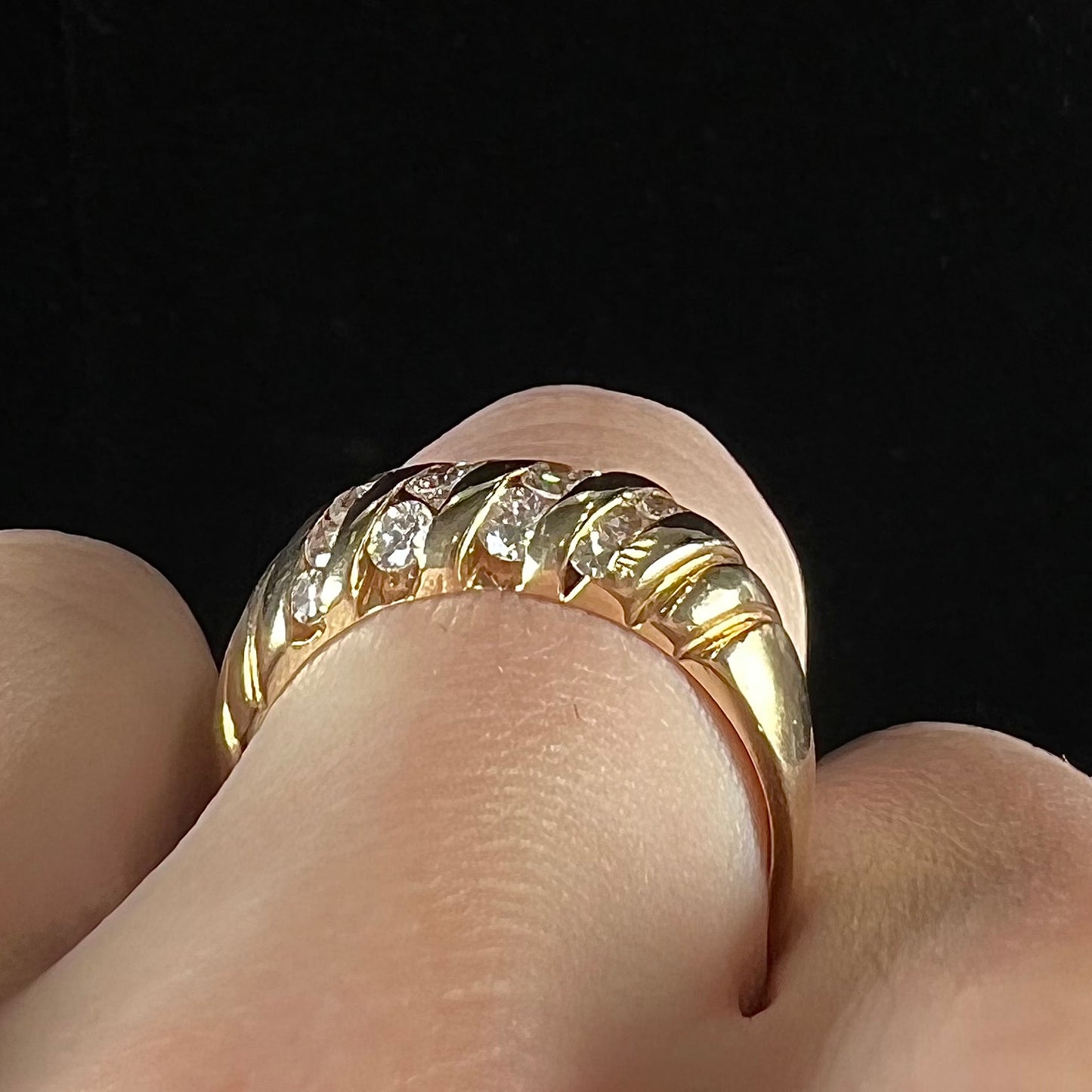 A ladies' channel set gold diamond ring.