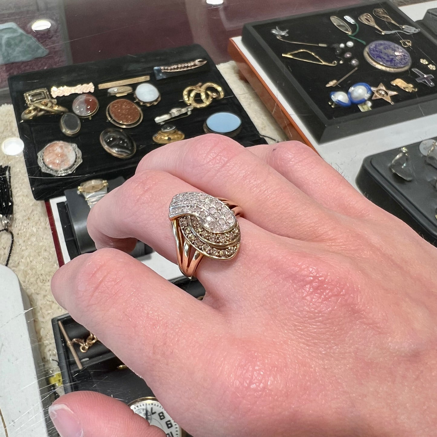 A ladies' 10 karat yellow gold split shank ring pave set with white and champagne colored diamonds.