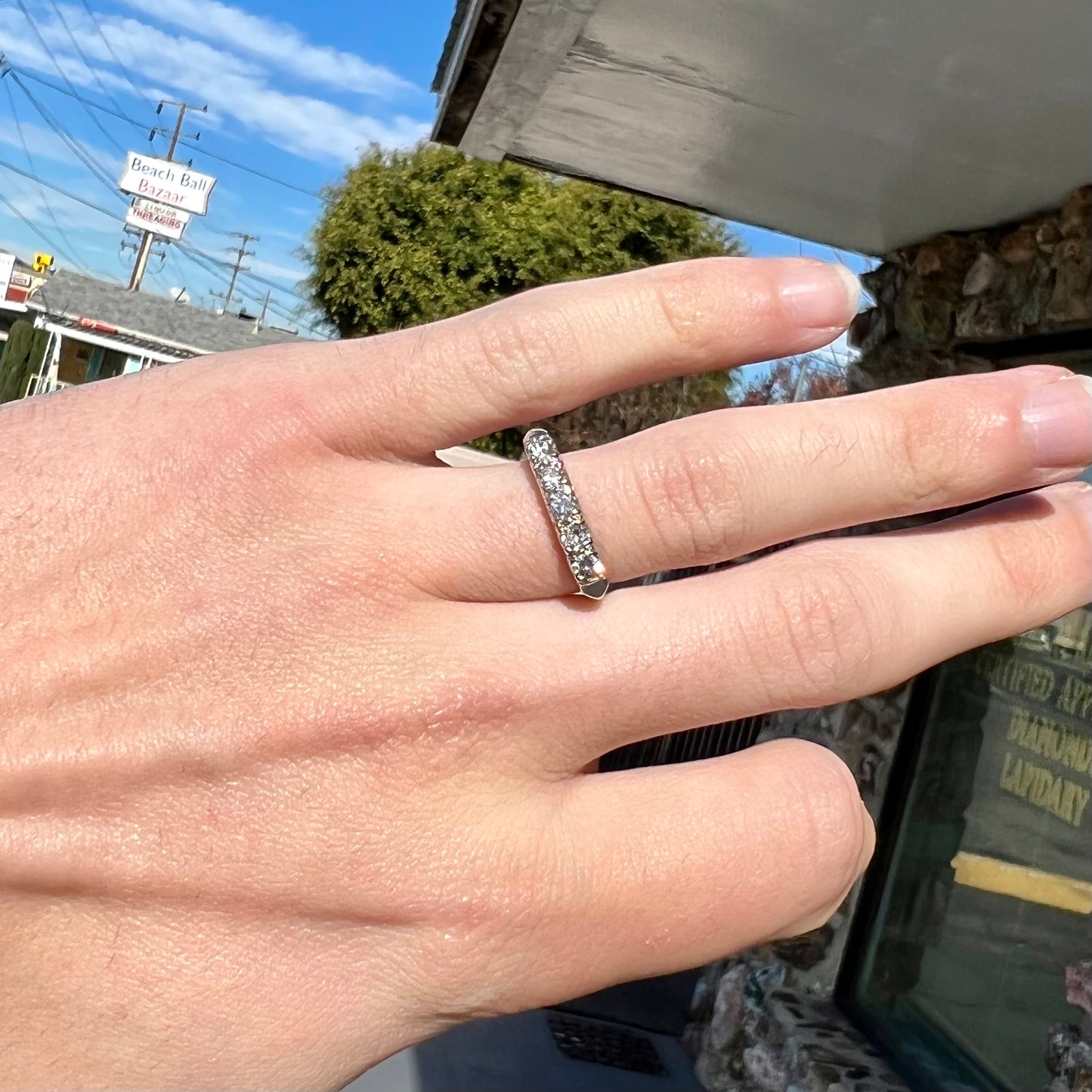 A vintage style ladies' platinum wedding band set with five round diamonds.