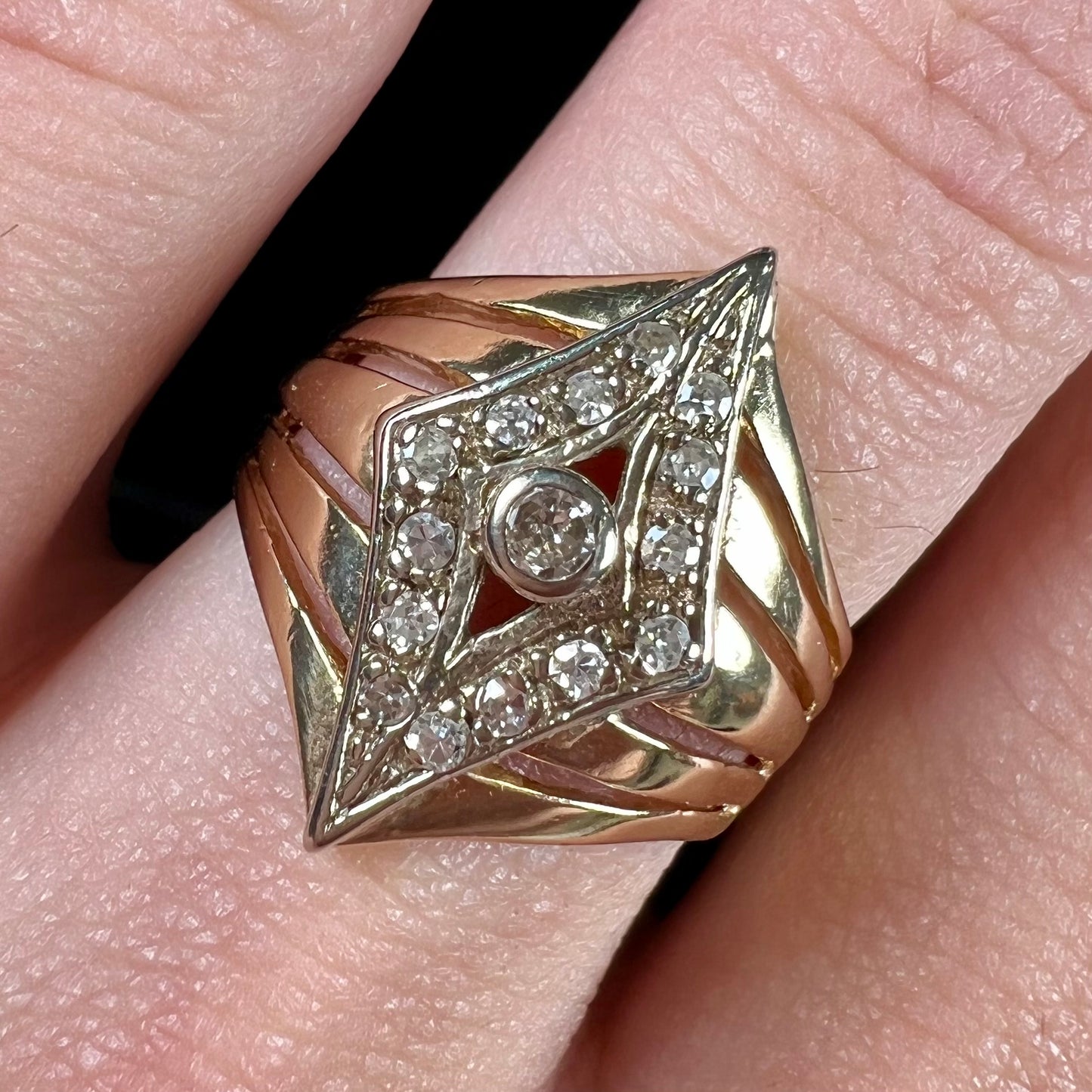 An estate ladies' gold diamond ring. The shape of the ring resembles an art deco style diamond.