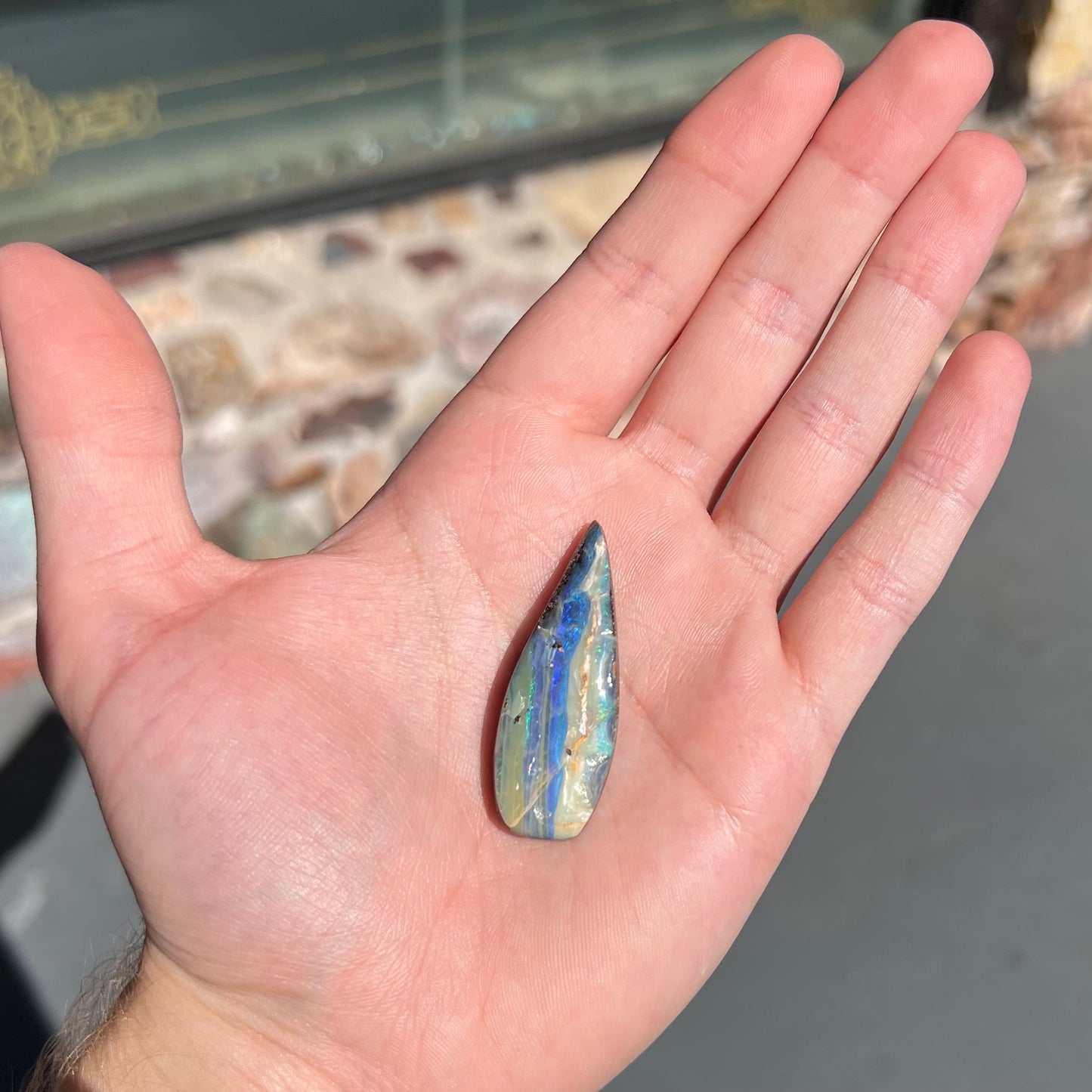 A loose, pear shaped boulder opal stone from Queensland, Australia.