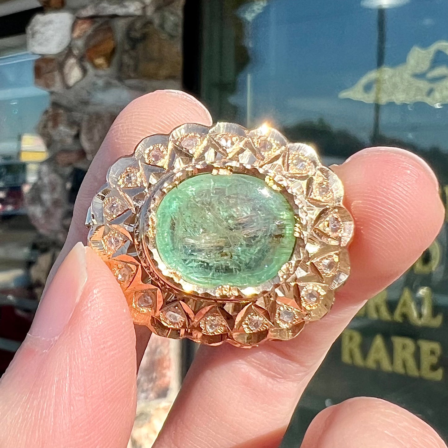 An antique 1800's Victorian emerald and diamond crystal brooch made in 18kt yellow gold.