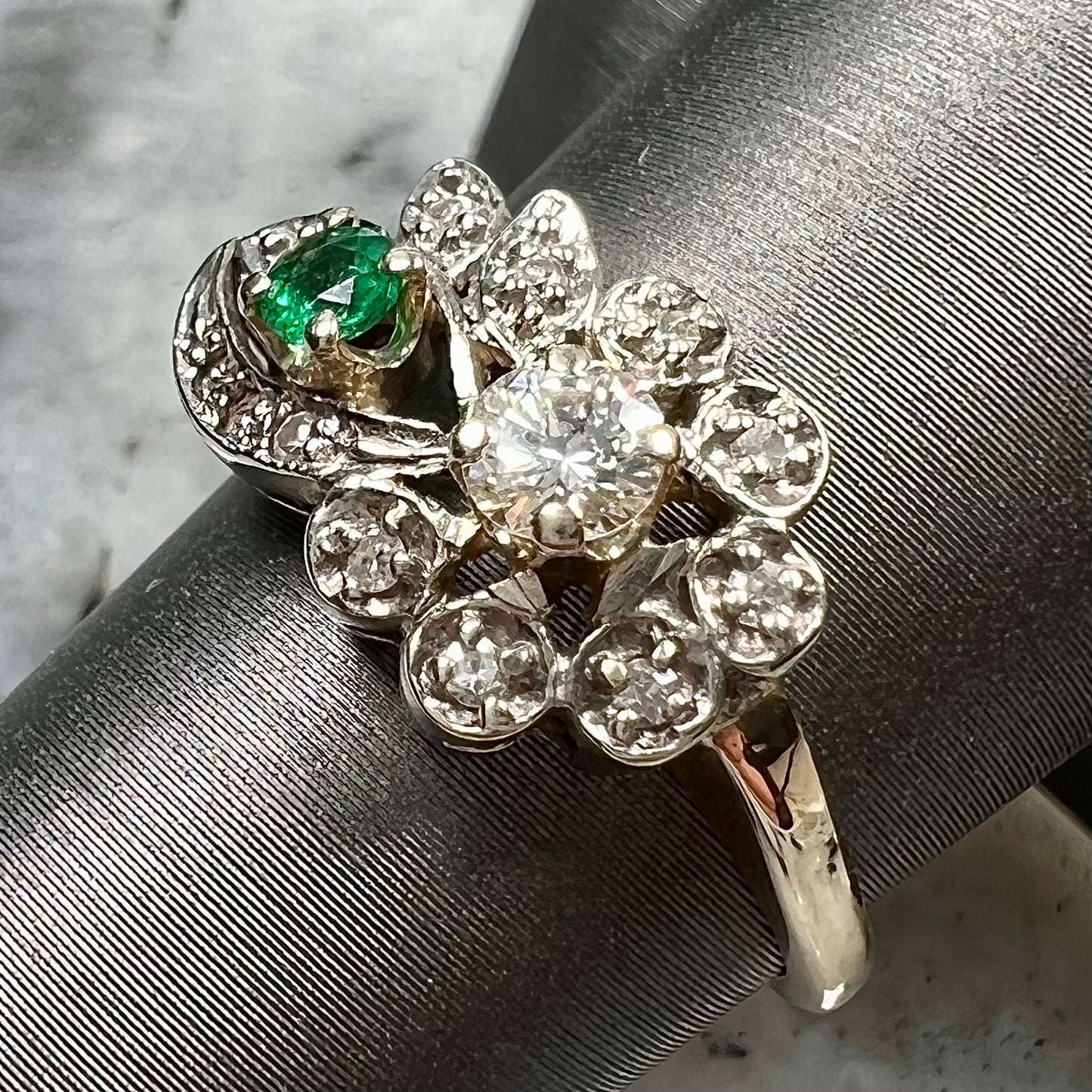 Vintage gold round cut emerald and diamond ring.
