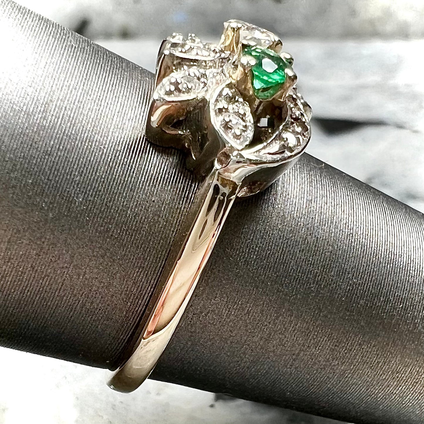 Vintage gold round cut emerald and diamond ring.