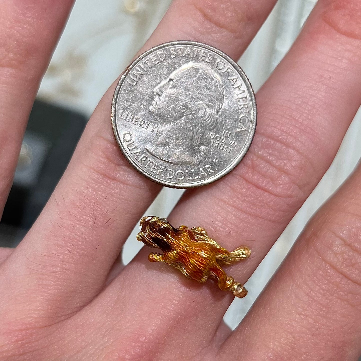 An estate 18kt yellow gold ring featuring a 3D enameled lion walking on a tree branch.