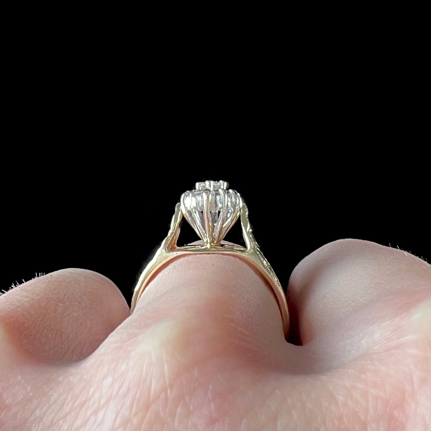 A ladies' estate diamond cluster ring cast in yellow gold. The shank has a nugget design.